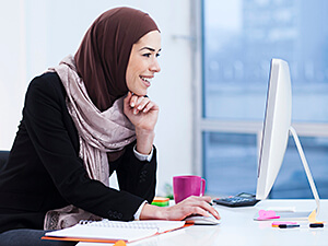 Arabic woman working on computer.